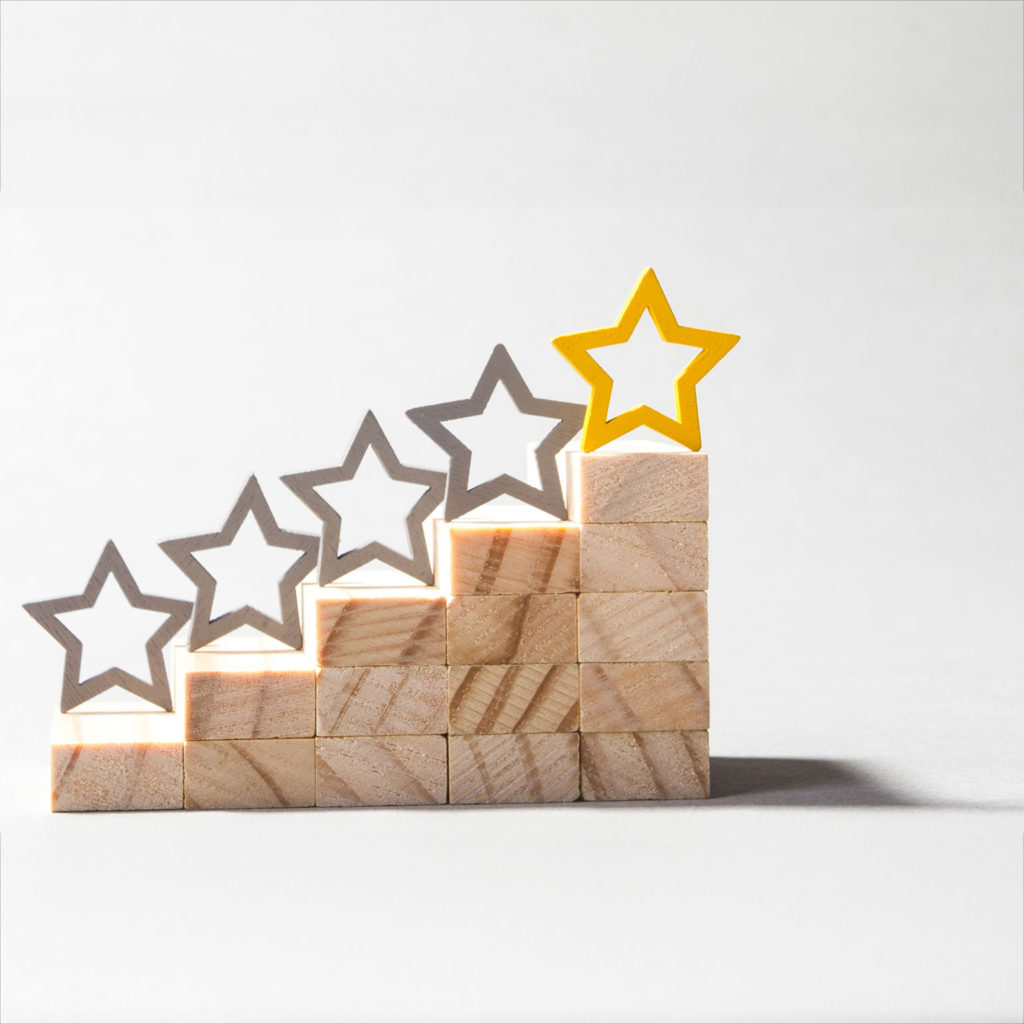 A set of five wooden block steps with stars on top